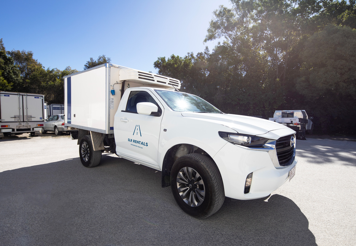 A white refrigerated ute parked in SLR Rentals parking lot