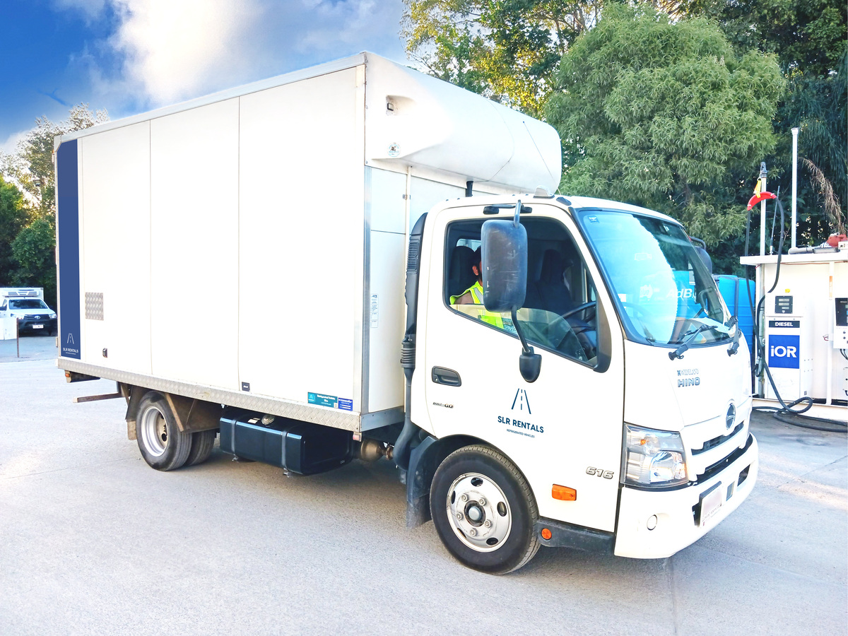 A white refrigerated ute parked in SLR Rentals parking lot